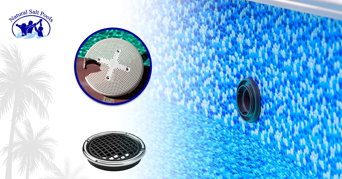 A blue, tiled pool wall witha balck water jet or return fitting on the right, and two different drain covers pictured on left.