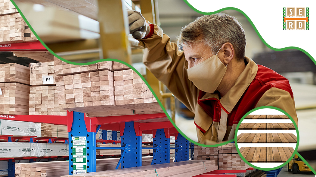 worker-checking-timber-with-wood-warehouse-and-wooden-platforms
